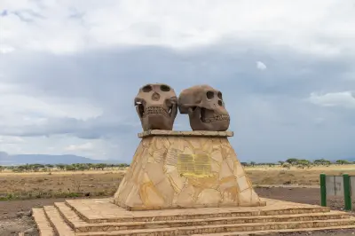 Olduvai Gorge entrance monument with two large hominin skull sculptures commemorating one of the world's most important archaeological and paleoanthropological sites in northern Tanzania.