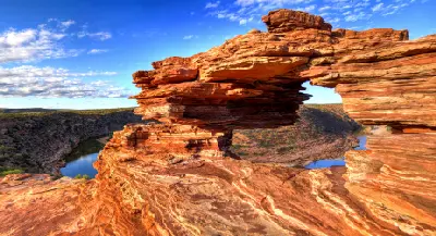 Layered sandstone arch of Nature's Window overlooking the Murchison River gorge.