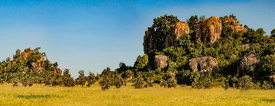 Granite rock formations surrounded by open grassland at Moru Kopjes in Serengeti National Park, Tanzania.