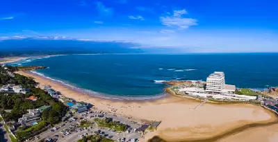 Aerial view of Lookout Beach and Beacon Isle in Plettenberg Bay, where the lagoon mouth meets the Indian Ocean along the Garden Route coastline.