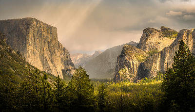 Tunnel View Yosemite Valley California showing El Capitan, Bridalveil Fall and forested valley floor between granite cliffs.