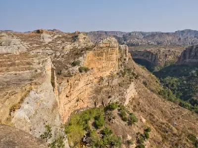 Layered sandstone cliffs overlooking a deep canyon system in Isalo National Park, Madagascar