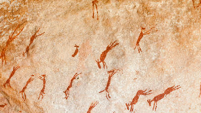 Ancient San rock art depicting antelope painted on a sandstone rock shelter wall in the Cederberg Mountains, Western Cape, South Africa.