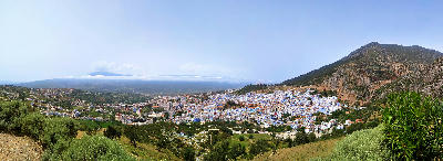 Panoramic view of Chefchaouen’s blue medina surrounded by the Rif Mountains in northern Morocco