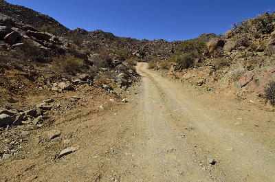 Rocky 4x4 track climbing through a narrow mountain valley in Richtersveld National Park, Northern Cape, South Africa.
