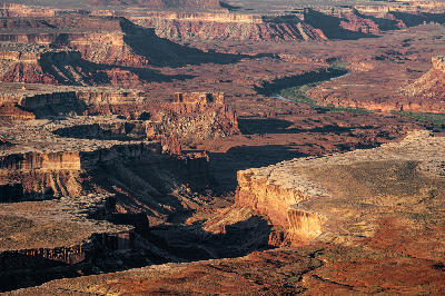 View from Green River Overlook showing river carving through mesas, cliffs, and layered canyon landscape in Canyonlands National Park Utah