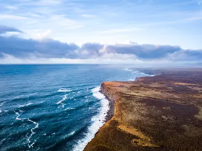 Drone view of the dramatic coastal cliffs of Krýsuvíkurberg on the Reykjanes Peninsula, Iceland, overlooking the Atlantic Ocean.
