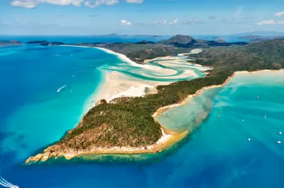Aerial view of Whitehaven Beach and Hill Inlet with white silica sand, turquoise water and forested Whitsunday Islands, Queensland, Australia.