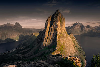 Steep granite peak of Segla above fjords and mountains at sunset on Senja Island