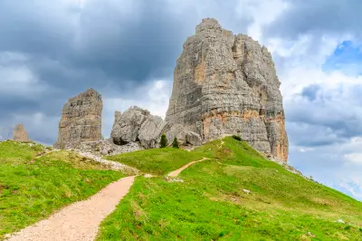 Spring view of Cinque Torri in the Dolomites, with the five rock towers rising above alpine terrain in Veneto, Italy.