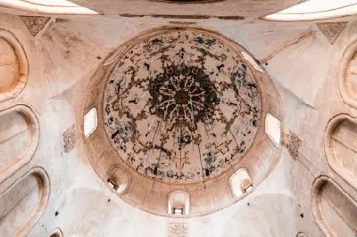 Interior view looking up at the historic painted dome and stonework of İshak Pasha Palace in Doğubayazıt, Turkey.